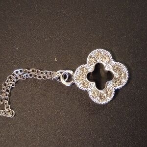 Necklace clover with black in the middle and crystals around it